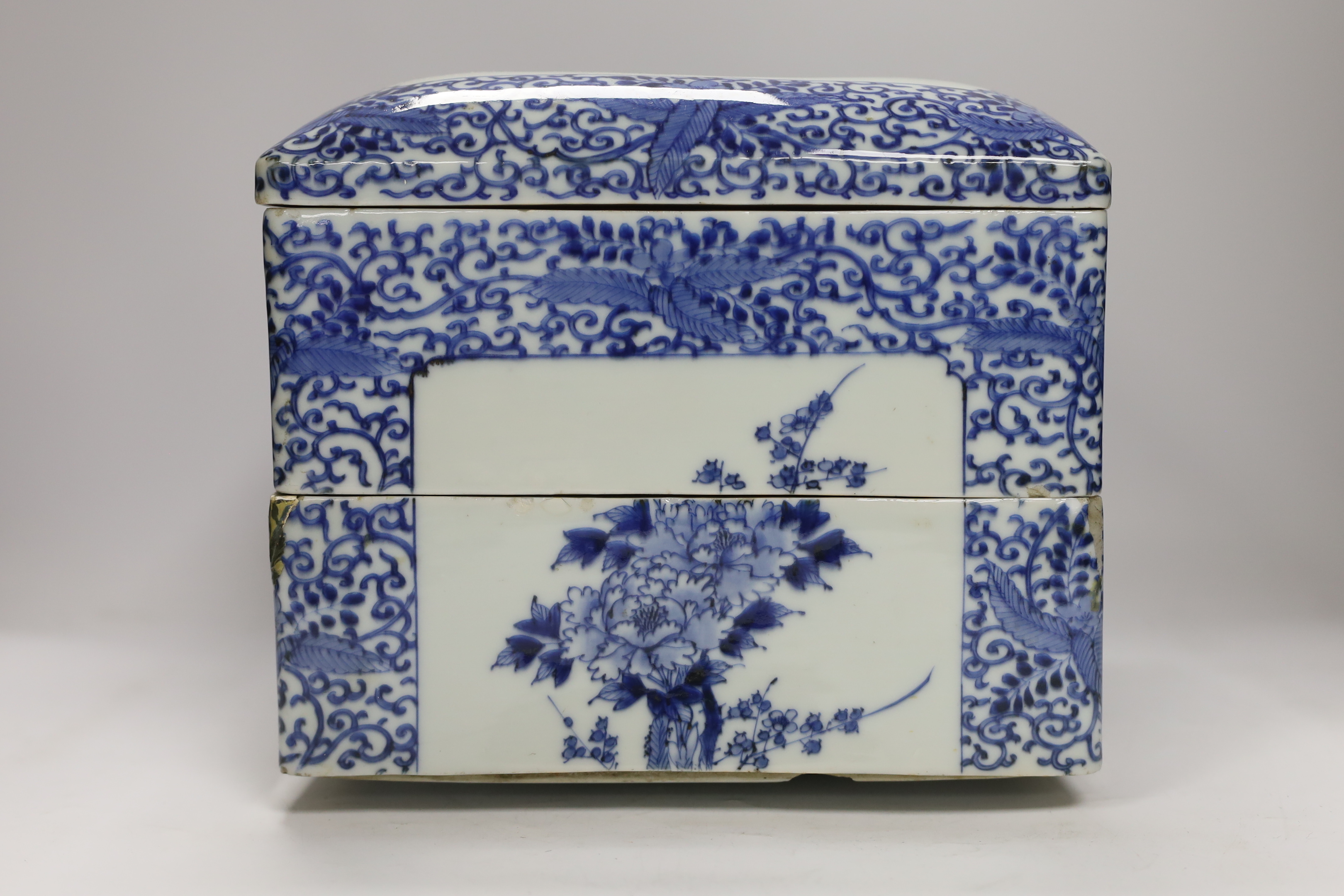 A Japanese blue and white floral, two tier food container with cover, 23cm high